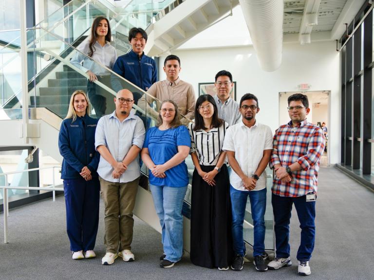 Park Lab members posed on a stair case.