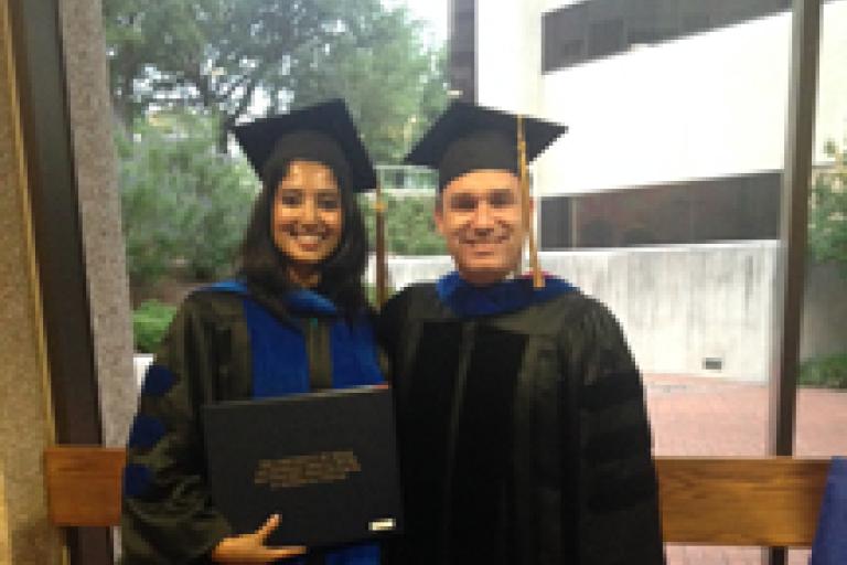 Dr. Shiloh and Vineetha pose as Vineetha holds her diploma