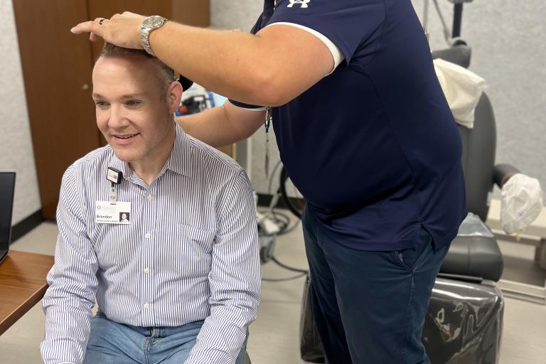 professor using TMS machine on person