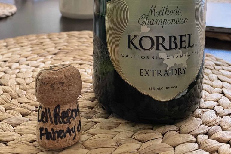Signed cork (Flaherty/Cell Reports) with empty champagne bottle.