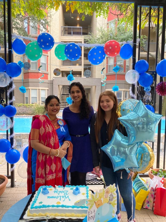 Maggie, Anju, and Alex standing and smiling
