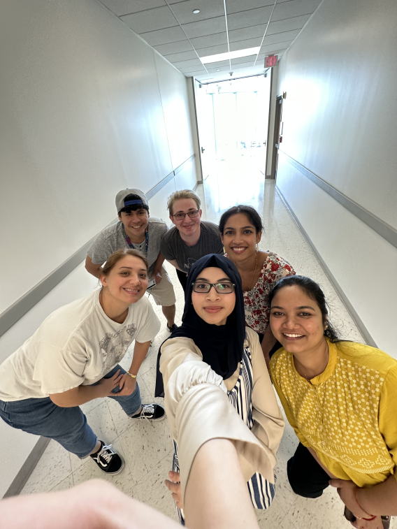 .5 Selfie taken by Zehra showing Alex, Zehra, and Maggie up front and Abner, Timea, and Anju in the back.