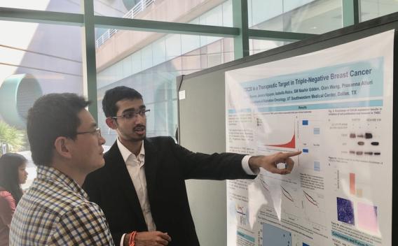 Two lab members looking at whiteboard