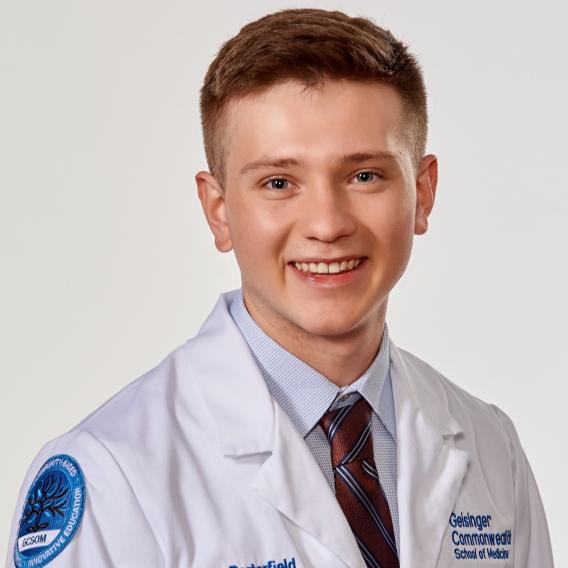 Zane Porterfield, B.S. wearing white coat