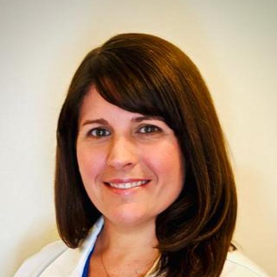 Dr. Rowe smiling, with long dark hair, wearing a lab coat, with "Pediatrics Infectious Disease"