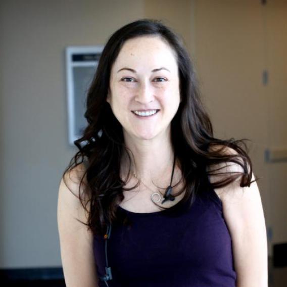 Kimberly Batten, smiling woman with long dark hair wearing a purple tank top.