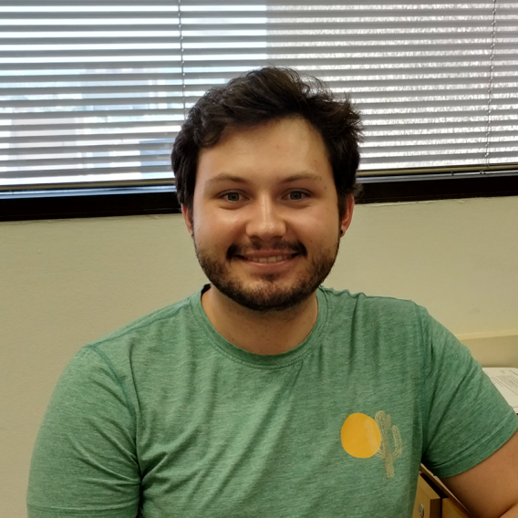 a man with sort brown hair, beard and mustache wearing a green t-shirt