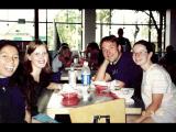 Four lab members smiling together at a diner