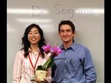 Dr. Sogame with lab member and gifted orchid