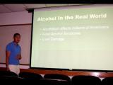 Lab member presenting slides in a classroom - Presentation: Alcohol in the Real World