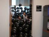 Team member in office filled with black balloons
