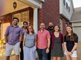 Conrad Lab Members gather on front porch of house
