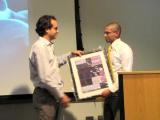 Raghu Chivukula Thesis Defense - Dr. Mendell presenting framed gift
