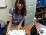 Kathryn With her "Congratulations" cake, champaign, glasses, plates and silverware.