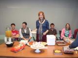 Four team members with Olga at her Baby Shower, with food on the table