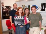 Olga holding movie chalkboard, with free team members