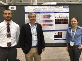 Greenberg Lab presenters standing in front of poster