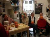 Five team members carving pumpkins