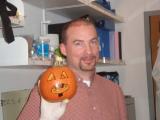 Team member holding a carved and decorated pumpkins