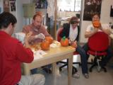Lab team members carve pumpkins
