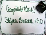 Cake with graduation hat decoration - "Contratulations! Stefan Bresson, PhD"