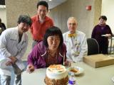 Team member blows out candles on cake at the Annual Lab Chili Party