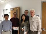 Siqi and her thesis committee as she receives a gift from the lab.