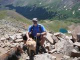 Dr. Mason and his dogs amid some majestically mountainous terrain.