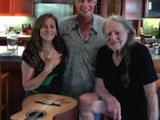 Annie and Willie Nelson autographing the “Stem Cell Guitar”