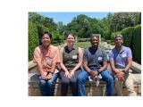 members of the Parikh lab on a park bench at the Dallas Arboretum