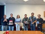 the lab group showing off white elephant gifts