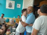 Dr. Malladi and Kangsan greet each other with a hug at a restaurant
