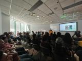 People sit in conference room watching a presentation