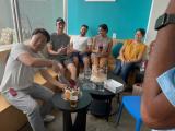Kangsan cuts a cake while others look on