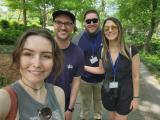 From left to right: Danielle, Mike, JD, and Anna take a selfie in front of greenery at the Dallas Arboretum