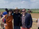 From left to right: Anna, Mike, and JD pose for a photo in front of the Derby track