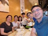 Lab members pose for group photo around table in restaurant