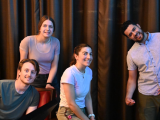 Two men and two women pose for the camera at a bowling alley