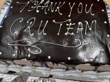 a chocolate cake with words "Thank you CRU Team"