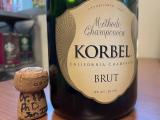 Champagne cork with Dr. Flaherty, PhD 2025 written on it next to bottle. 
