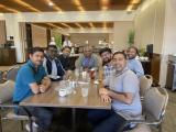 members of the Poojary lab around a table