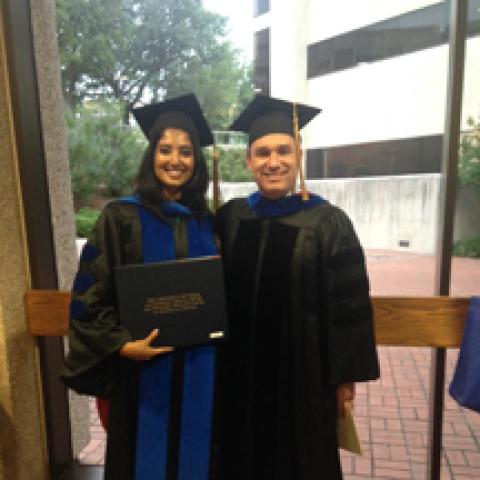 Dr. Shiloh and Vineetha pose as Vineetha holds her diploma