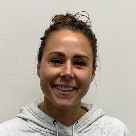 Headshot of a woman against a blank wall