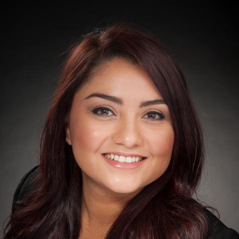 Headshot of a woman against a blank wall