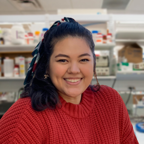 Natalie Noreen, wearking a red sweater and  lab member on the Ank Nijhawan research team