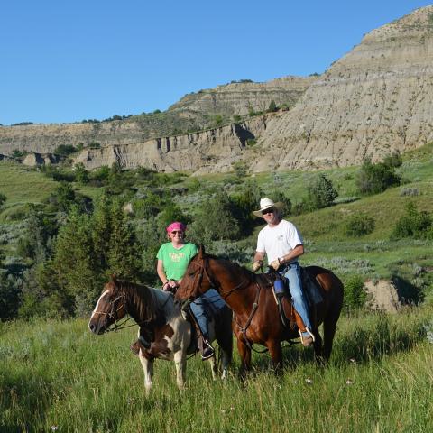 Dr. Monson and husband on horseback