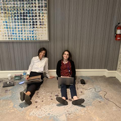 two women sitting on the floor