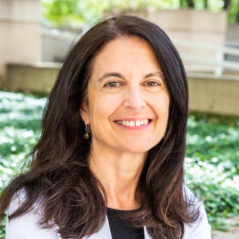 Suzanne D. Conzen, M.D. a woman with long dark hair standing in an outdoor setting