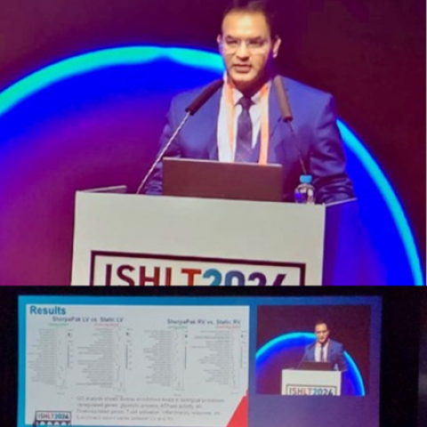 Man with dark hair wearing a blue suit standing at a podium, with inset of an unreadable page titled, Results.