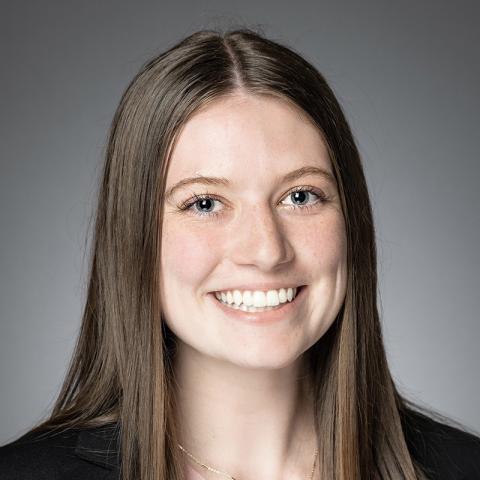 Smiling woman with long brown hair.